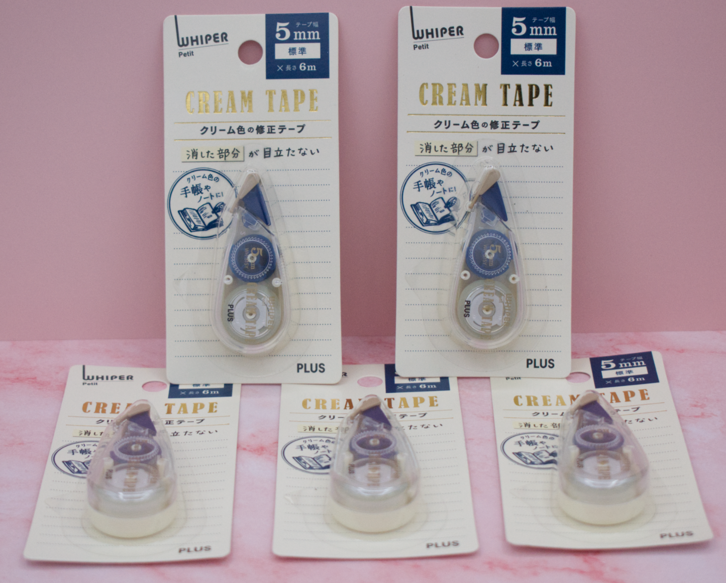 Five packages of 5mm Whiper Petit Plus brand cream tape on a pink background