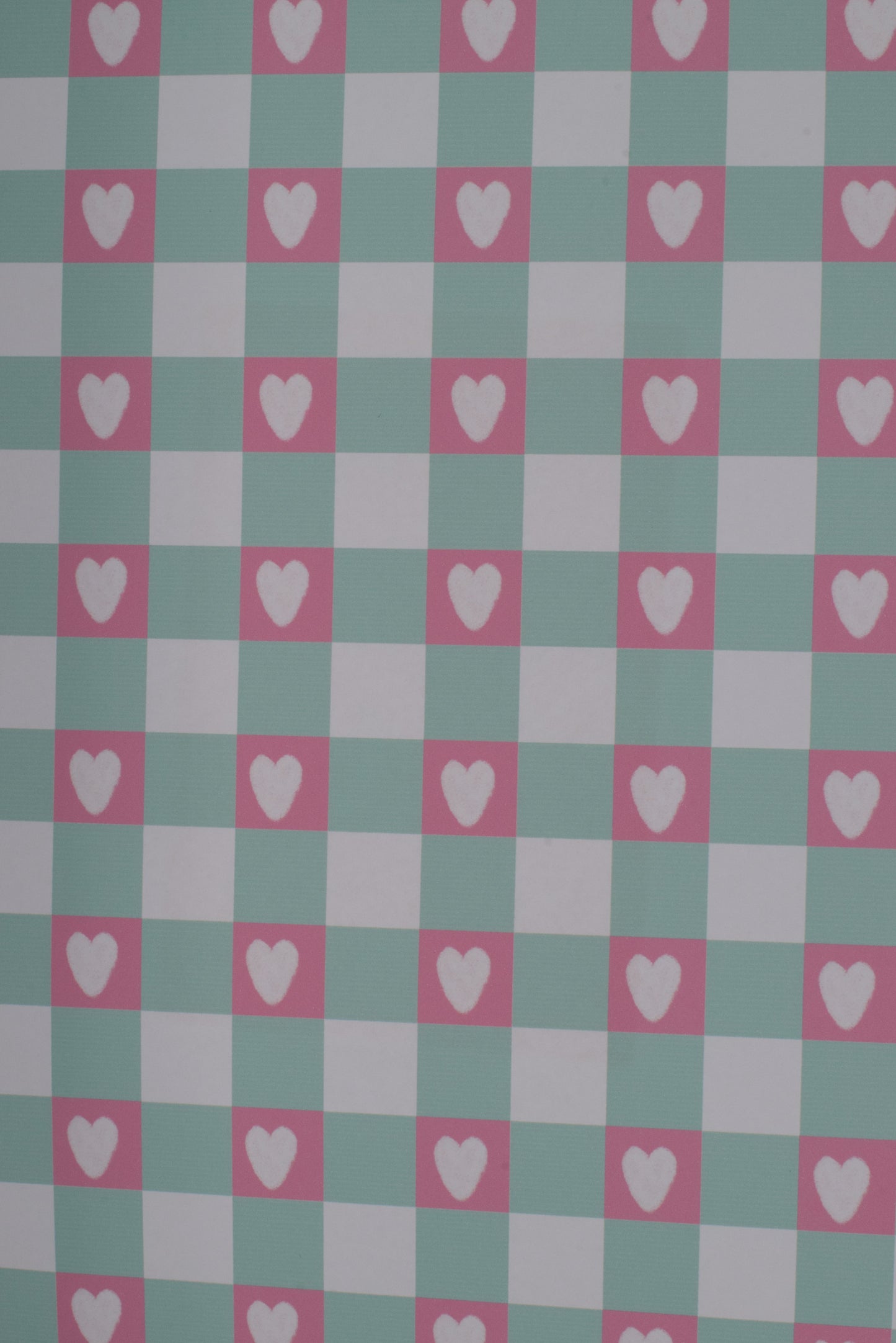 Checkered pattern with hearts on a green and pink background