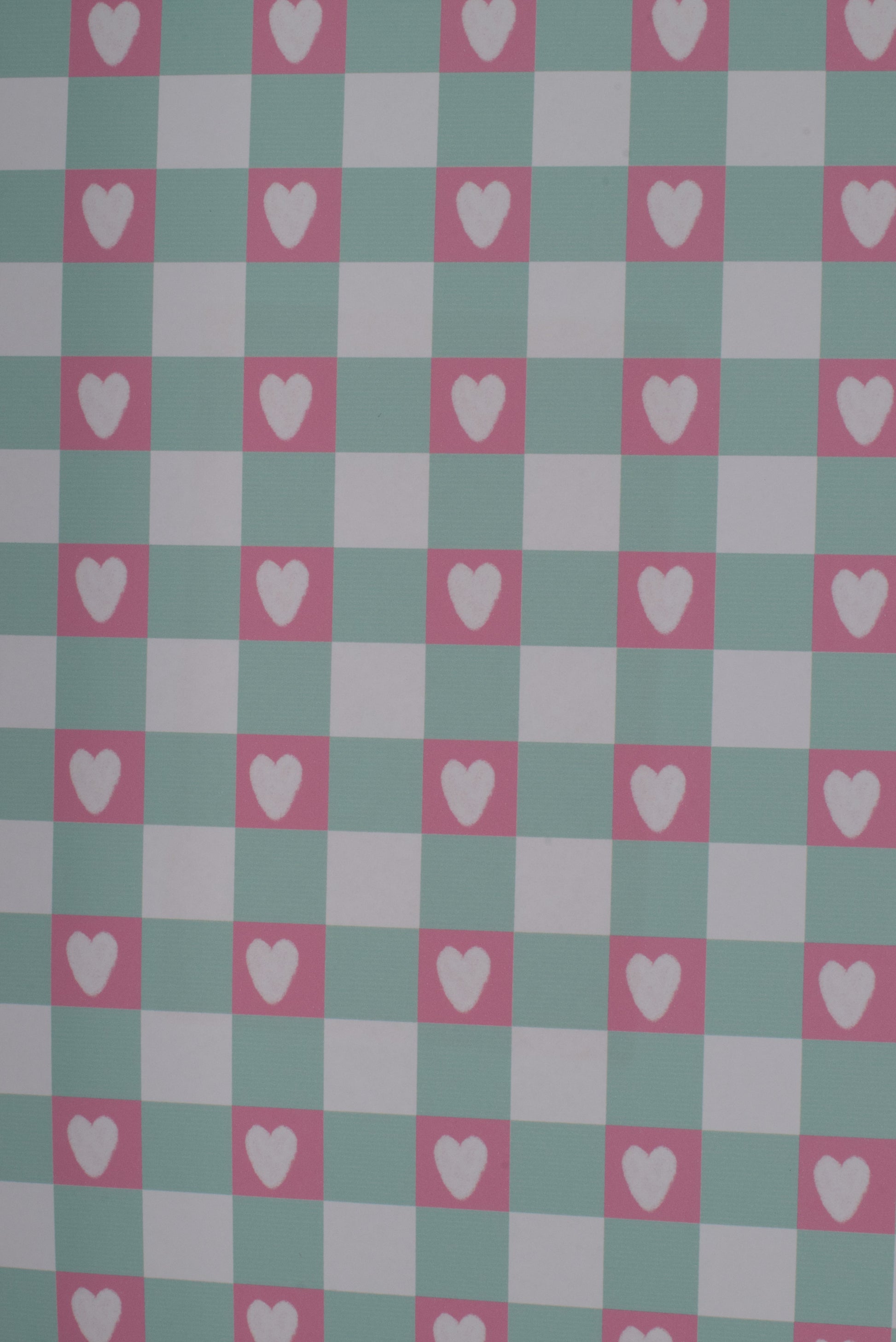 Checkered pattern with hearts on a green and pink background