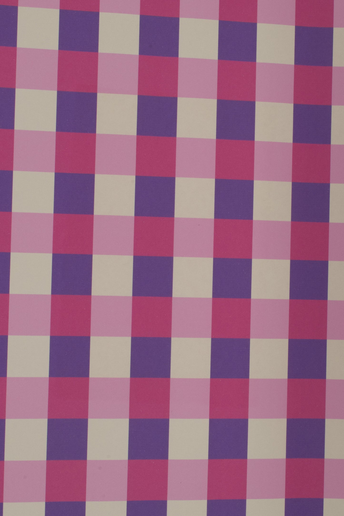 Checkered fabric with a pattern of pink, purple, and beige squares on a white background
