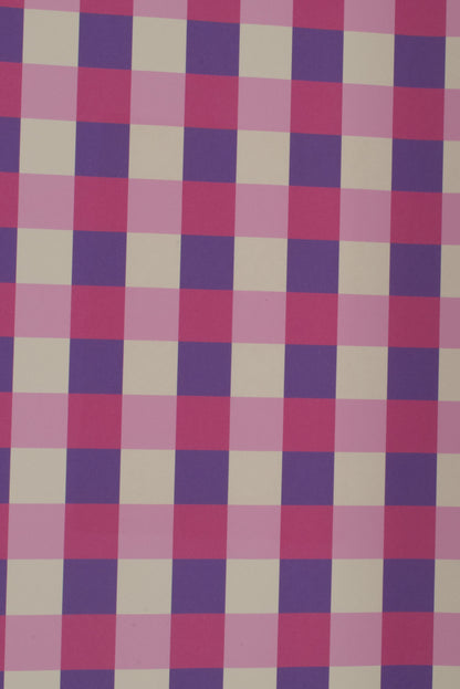 Checkered fabric with a pattern of pink, purple, and beige squares on a white background